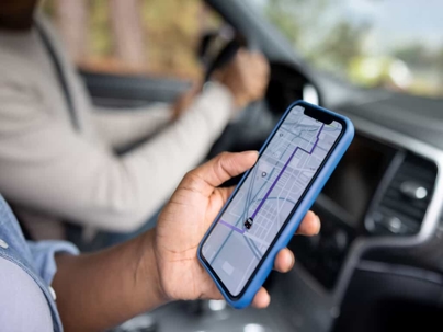 Man Looking at Ridesharing App in Car